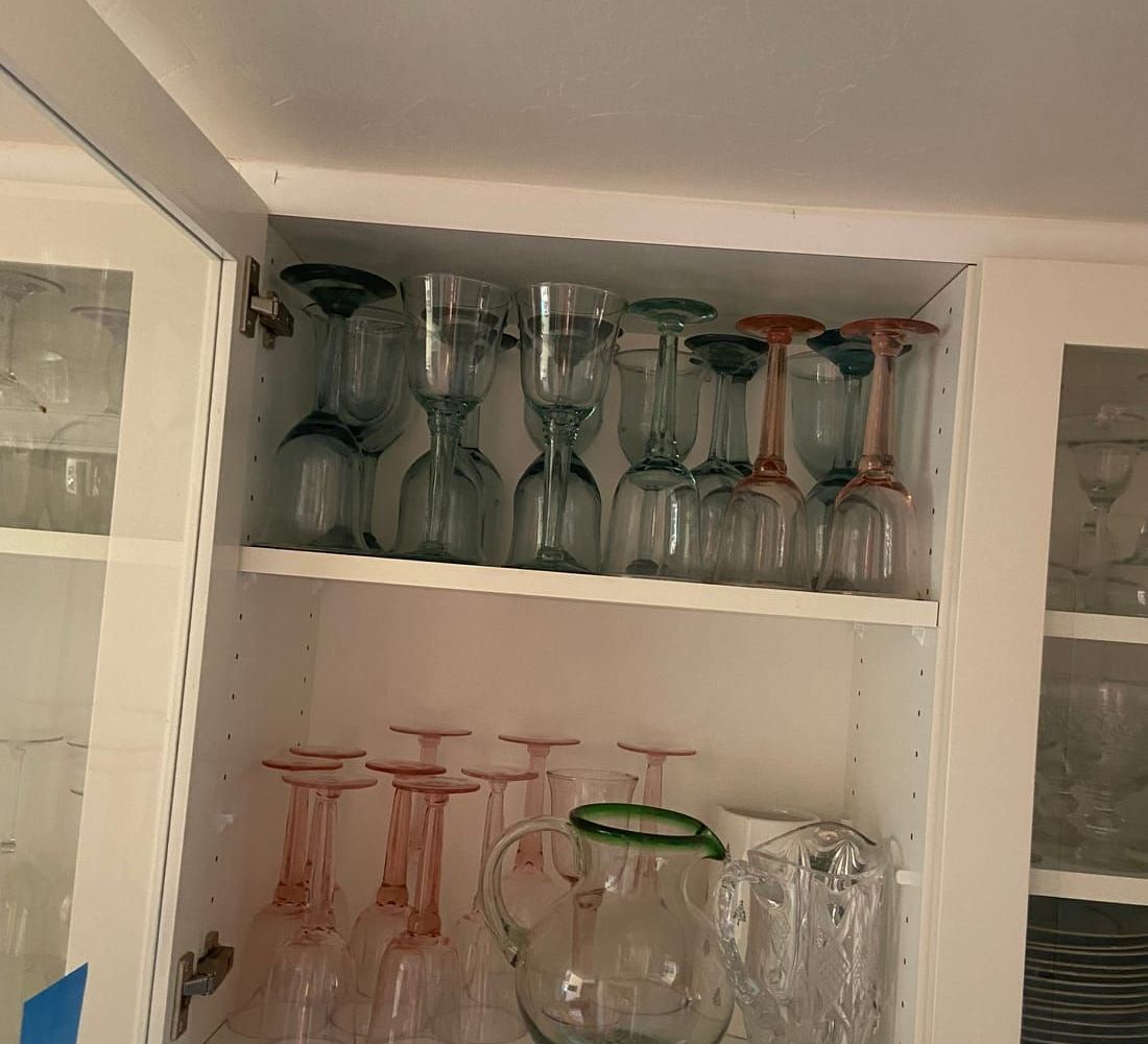 A cabinet full of family glassware waiting to be sorted